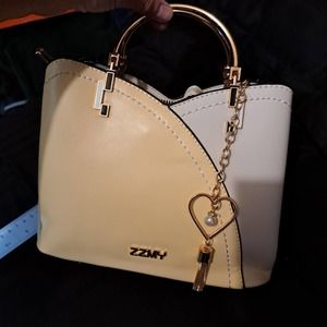 New with tags darling yellow and cream gold metal handles